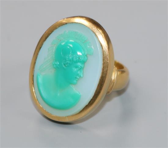 A 1950s 22ct gold and sardonyx set oval ring, carved with head of a Roman soldier to sinister, size K.